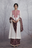 AN EMBROIDERED LINEN JACKET STYLED WITH A BROWN TUSSAR SAREE FOR A QUIETLY STRIKING LOOK.