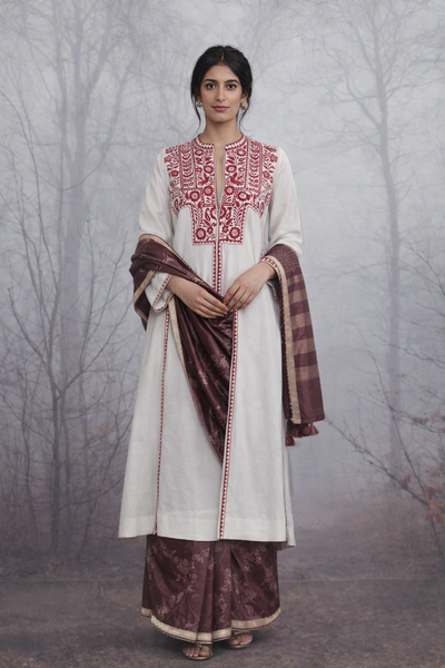AN EMBROIDERED LINEN JACKET STYLED WITH A BROWN TUSSAR SAREE FOR A QUIETLY STRIKING LOOK.