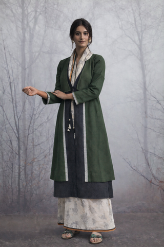 A CHECK JACKET LAYERED OVER A PRINTED SAREE FOR EFFORTLESS BALANCE.