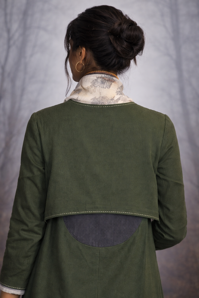 A CHECK JACKET LAYERED OVER A PRINTED SAREE FOR EFFORTLESS BALANCE.