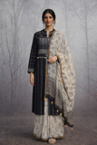 A LINEN JACKET LAYERED OVER A SOFTLY DRAPED TUSSAR SAREE.