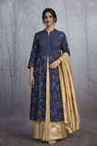 A STRUCTURED BLUE JACKET WITH A SOFT SILK TISSUE SAREE, BALANCED IN CONTRAST AND EASE.