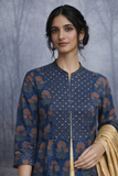 A STRUCTURED BLUE JACKET WITH A SOFT SILK TISSUE SAREE, BALANCED IN CONTRAST AND EASE.