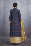 A STRUCTURED BLUE JACKET WITH A SOFT SILK TISSUE SAREE, BALANCED IN CONTRAST AND EASE.