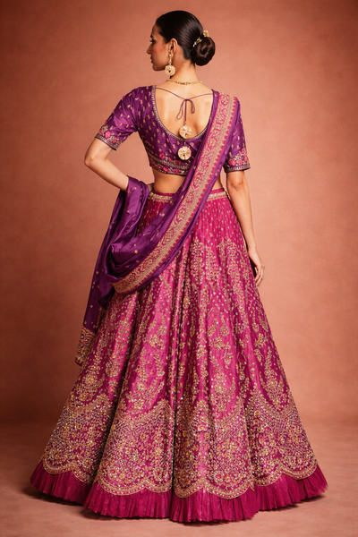 A RICH PURPLE DUPION SILK EMBROIDERED BLOUSE PAIRED WITH A HEAVY FALSA SCALLOP LEHENGA AND A MATCHING PURPLE DUPATTA.(FB-01)
