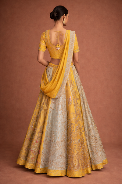 A YELLOW LEHENGA PAIRED WITH A MATCHING EMBROIDERED BLOUSE AND A SOFT POWDER BLUE PANEL WITH DUPATTA.(KA-01B)