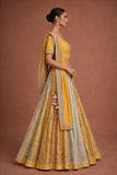 A YELLOW LEHENGA PAIRED WITH A MATCHING EMBROIDERED BLOUSE AND A SOFT POWDER BLUE PANEL WITH DUPATTA.(KA-01B)