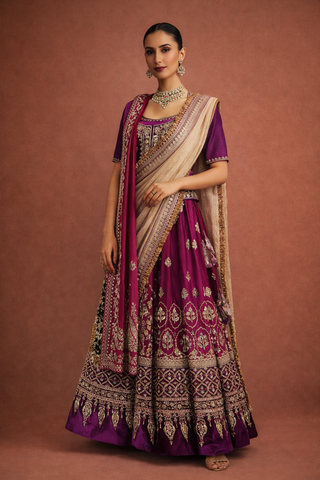 A DEEP PURPLE LEHENGA PAIRED WITH A MATCHING EMBROIDERED BLOUSE AND A CONTRAST GREEN AND PURPLE DUPATTA. (KS-15)