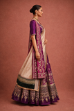 A DEEP PURPLE LEHENGA PAIRED WITH A MATCHING EMBROIDERED BLOUSE AND A CONTRAST GREEN AND PURPLE DUPATTA. (KS-15)