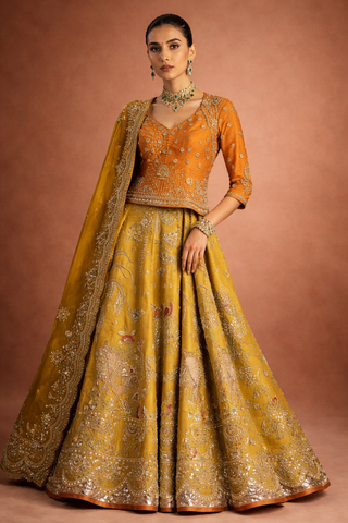 A MUSTARD LEHENGA PAIRED WITH A RICH ORANGE EMBROIDERED BLOUSE AND A MATCHING DUPATTA. (FA-55)
