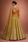 A MUSTARD LEHENGA PAIRED WITH A RICH ORANGE EMBROIDERED BLOUSE AND A MATCHING DUPATTA. (FA-55)