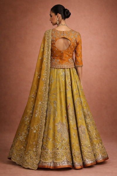 A MUSTARD LEHENGA PAIRED WITH A RICH ORANGE EMBROIDERED BLOUSE AND A MATCHING DUPATTA. (FA-55)
