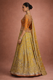 A MUSTARD LEHENGA PAIRED WITH A RICH ORANGE EMBROIDERED BLOUSE AND A MATCHING DUPATTA. (FA-55)