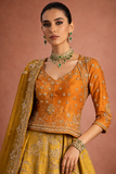 A MUSTARD LEHENGA PAIRED WITH A RICH ORANGE EMBROIDERED BLOUSE AND A MATCHING DUPATTA. (FA-55)