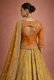 A MUSTARD LEHENGA PAIRED WITH A RICH ORANGE EMBROIDERED BLOUSE AND A MATCHING DUPATTA. (FA-55)
