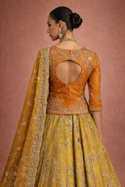 A MUSTARD LEHENGA PAIRED WITH A RICH ORANGE EMBROIDERED BLOUSE AND A MATCHING DUPATTA. (FA-55)