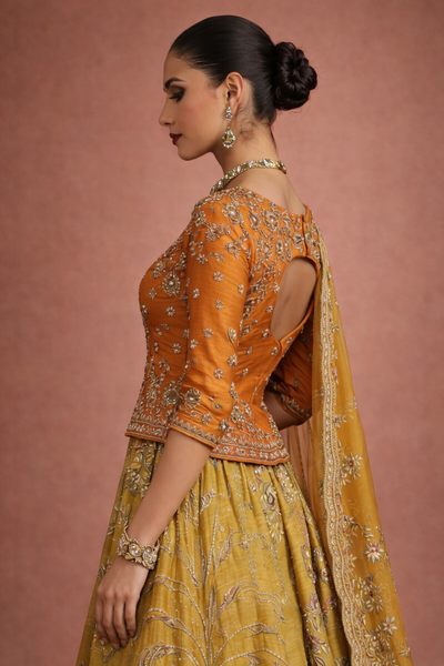 A MUSTARD LEHENGA PAIRED WITH A RICH ORANGE EMBROIDERED BLOUSE AND A MATCHING DUPATTA. (FA-55)