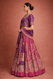 A RICH PURPLE DUPION SILK EMBROIDERED BLOUSE PAIRED WITH A HEAVY FALSA SCALLOP LEHENGA AND A MATCHING PURPLE DUPATTA.(FB-01)