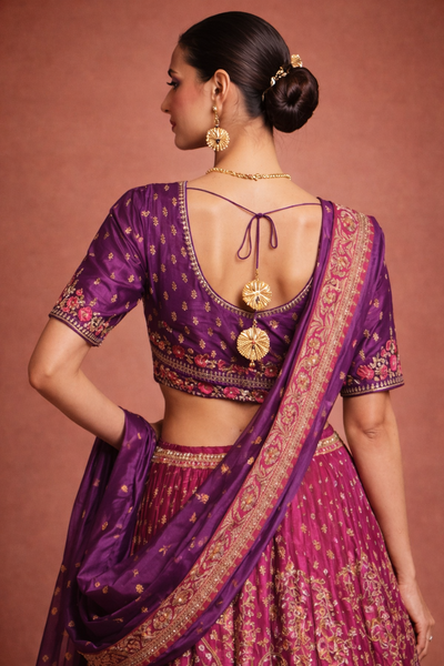 A RICH PURPLE DUPION SILK EMBROIDERED BLOUSE PAIRED WITH A HEAVY FALSA SCALLOP LEHENGA AND A MATCHING PURPLE DUPATTA.(FB-01)
