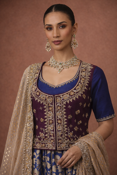 A ROYAL BLUE LEHENGA PAIRED WITH A DEEP WINE EMBROIDERED BLOUSE AND A SOFT GOLD DUPATTA.(TL-013)