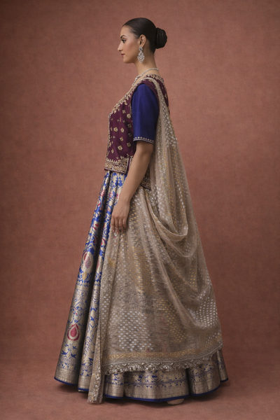 A ROYAL BLUE LEHENGA PAIRED WITH A DEEP WINE EMBROIDERED BLOUSE AND A SOFT GOLD DUPATTA.(TL-013)