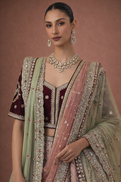A BLUSH PINK LEHENGA PAIRED WITH A DEEP WINE EMBROIDERED BLOUSE (TL-103)