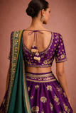 A REGAL PURPLE LEHENGA WITH A CONTRAST GREEN AND PURPLE DUPATTA.