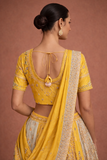 A YELLOW LEHENGA PAIRED WITH A MATCHING EMBROIDERED BLOUSE AND A SOFT POWDER BLUE PANEL WITH DUPATTA.(KA-01B)