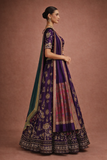 A REGAL PURPLE LEHENGA WITH A CONTRAST GREEN AND PURPLE DUPATTA.