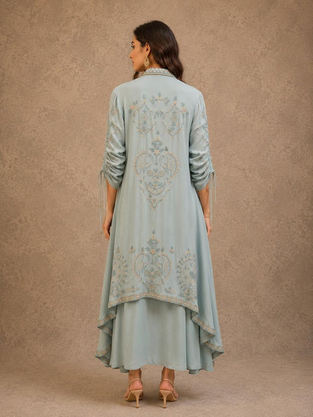 POWDER BLUE INNER DRESS PAIRED WITH AN EMBROIDERED CAPE JACKET FOR AN EFFORTLESSLY ELEGANT LOOK.