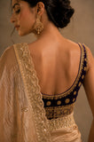 Woman wearing a traditional embroidered blouse with a plain background