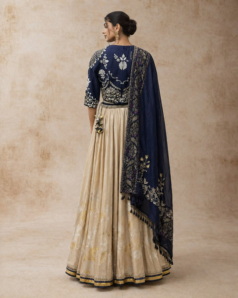 A NAVY BLUE EMBROIDERED BLOUSE PAIRED WITH A CONTRAST GOLD SKIRT AND A MATCHING DUPATTA.(3PCS)