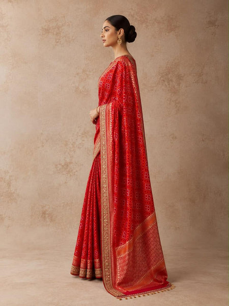 A BRIGHT RED SAREE WITH GEOMETRIC PATTERNS AND A DETAILED GOLD BORDER.(2PCS)