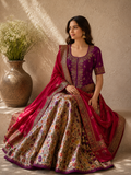 VIBRANT MAGENTA LEHENGA SET FEATURING INTRICATE EMBROIDERY, FLORAL PATTERNS, AND A RICHLY DETAILED DUPATTA.
